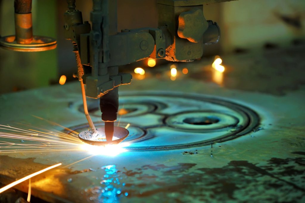 A precise laser cutting a circular pattern in metal.
