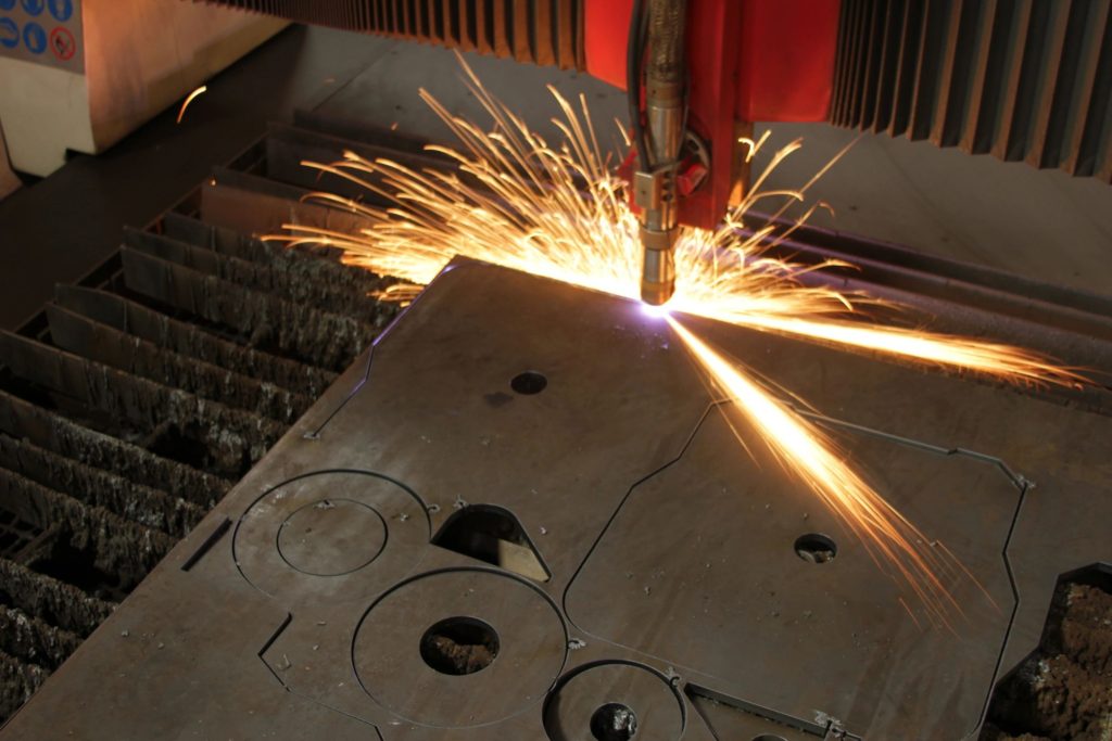 Close-up of a metal cutting process with sparks flying.